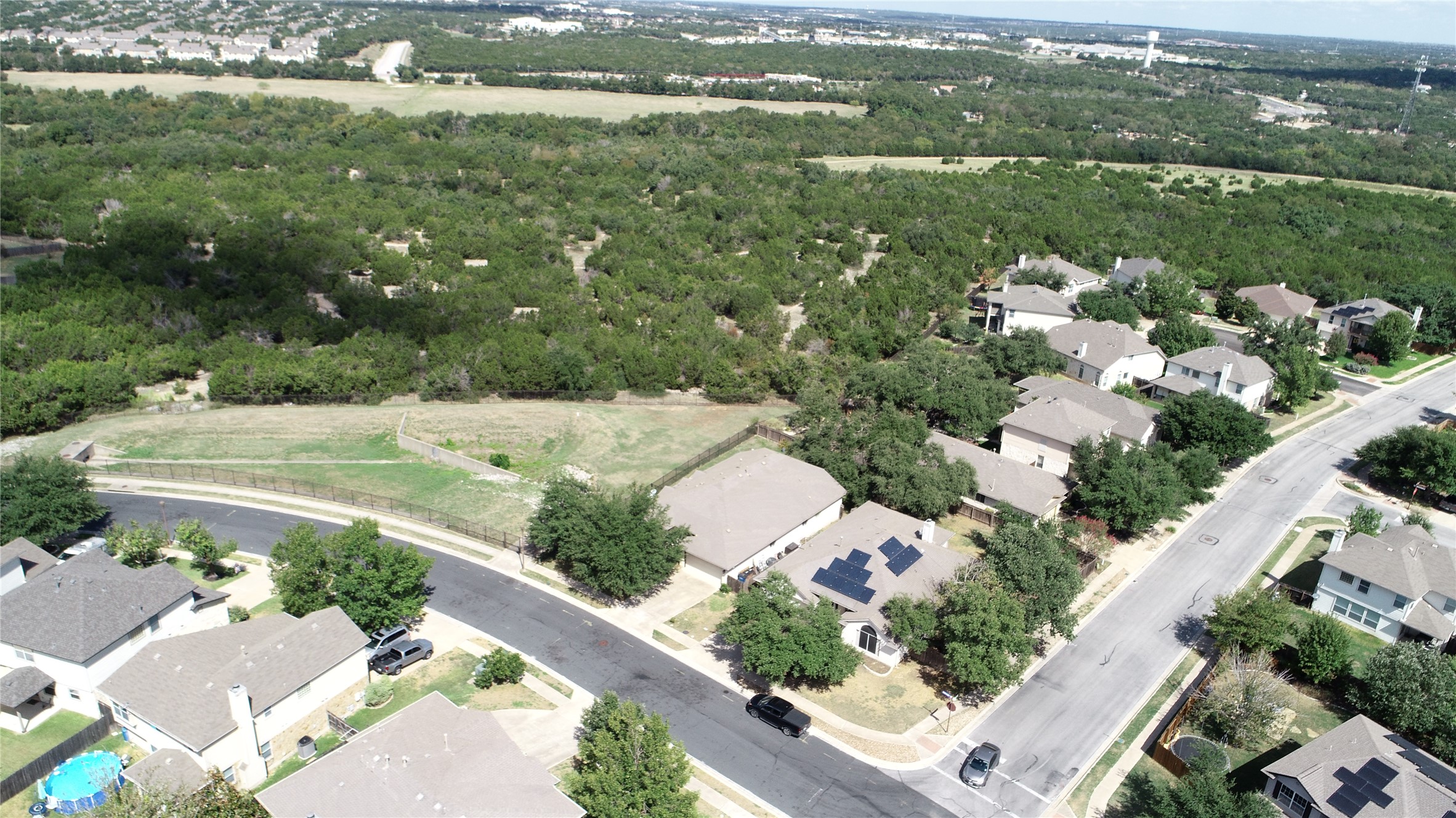 14901 Staked Plains Loop Austin, TX 78717 - Photo 30 of 30 Aerial view of property and surrounding area with nearby suburban area and a forest