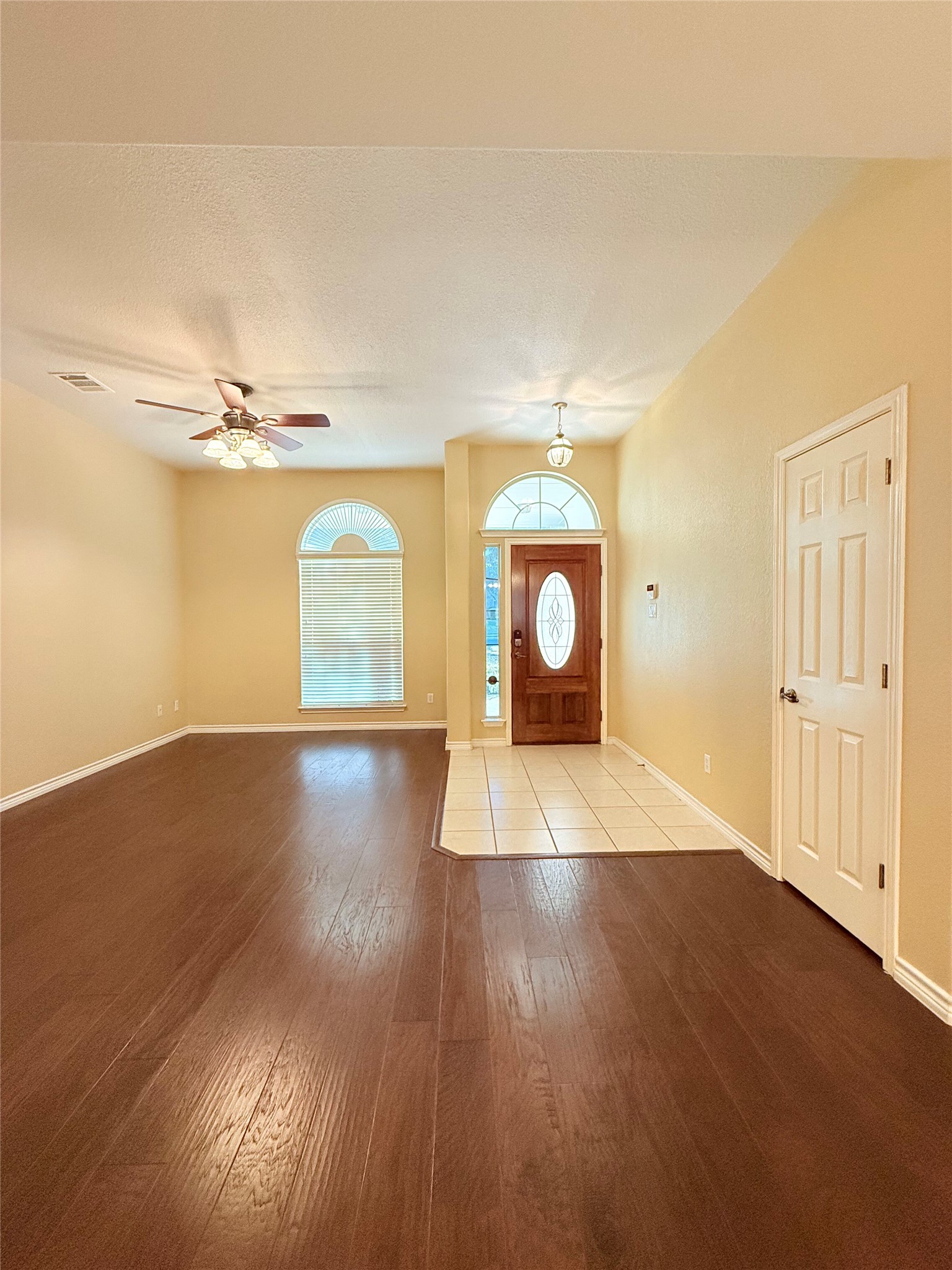 14901 Staked Plains Loop Austin, TX 78717 - Photo 5 of 30 Entrance foyer with wood finished floors, a textured ceiling, and ceiling fan