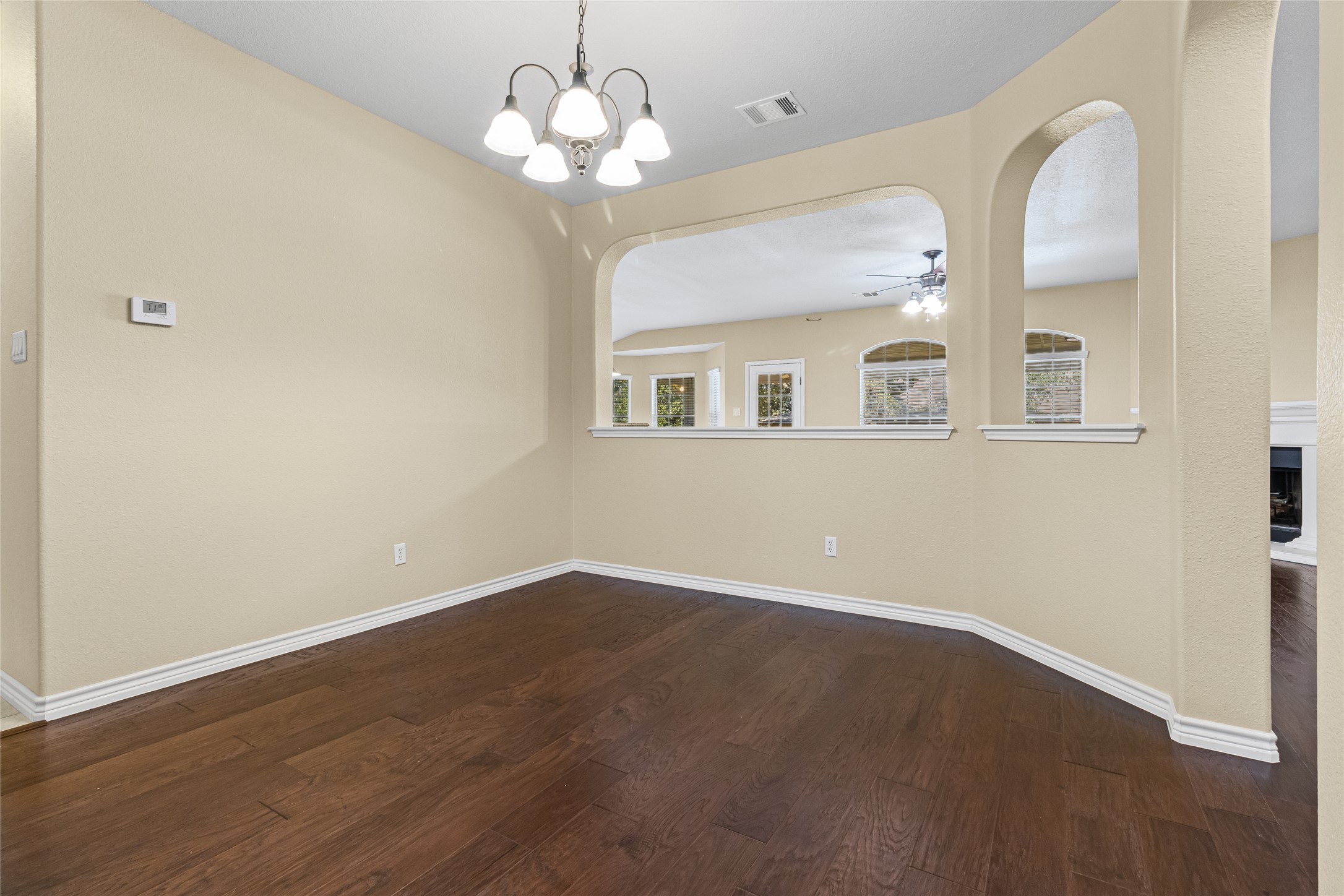 14901 Staked Plains Loop Austin, TX 78717 - Photo 7 of 30 Wood floors, arched walkways, a chandelier