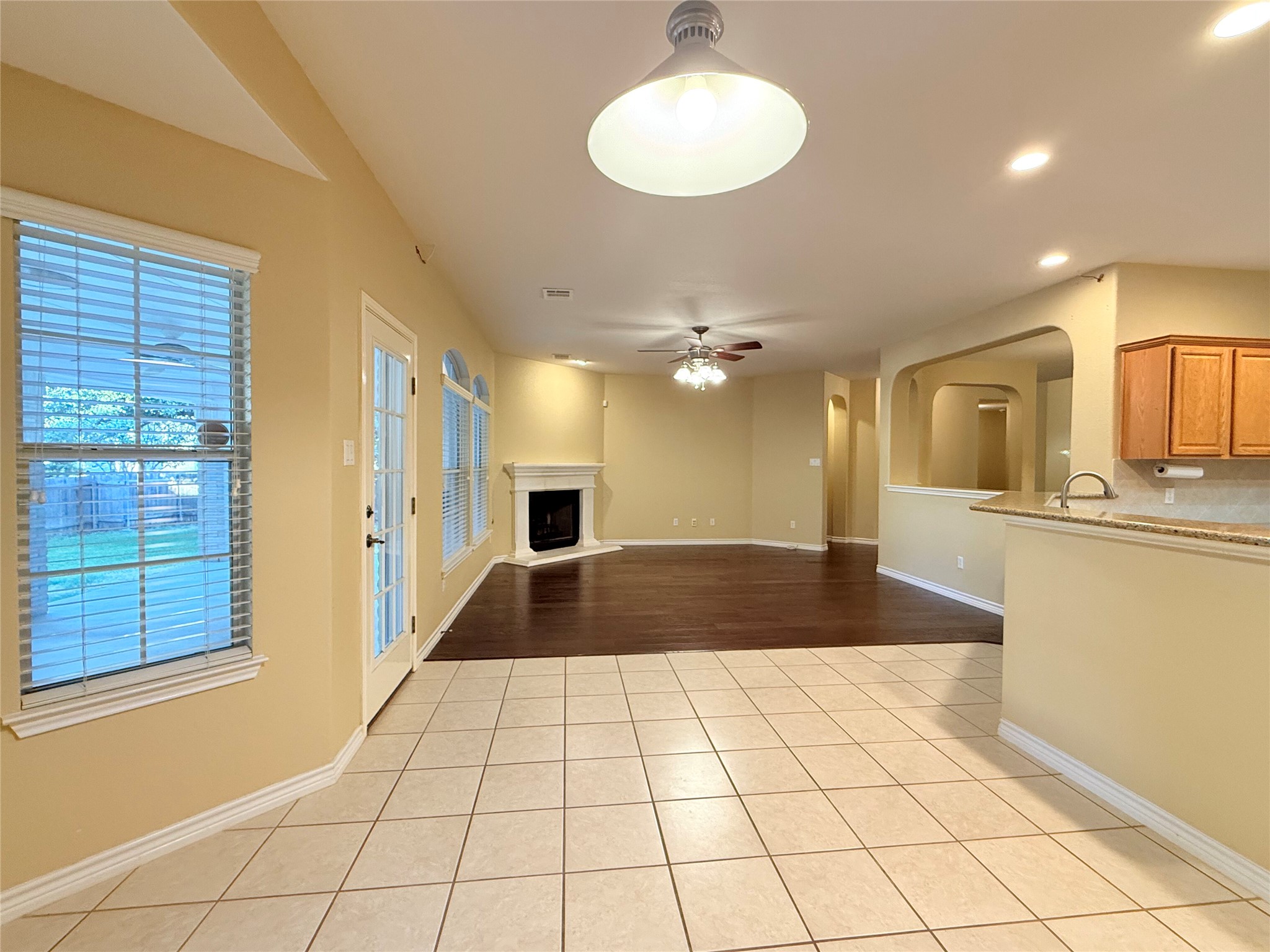 14901 Staked Plains Loop Austin, TX 78717 - Photo 10 of 30 Breakfast with light tile patterned floors, ceiling fan, a fireplace with raised hearth, and recessed lighting