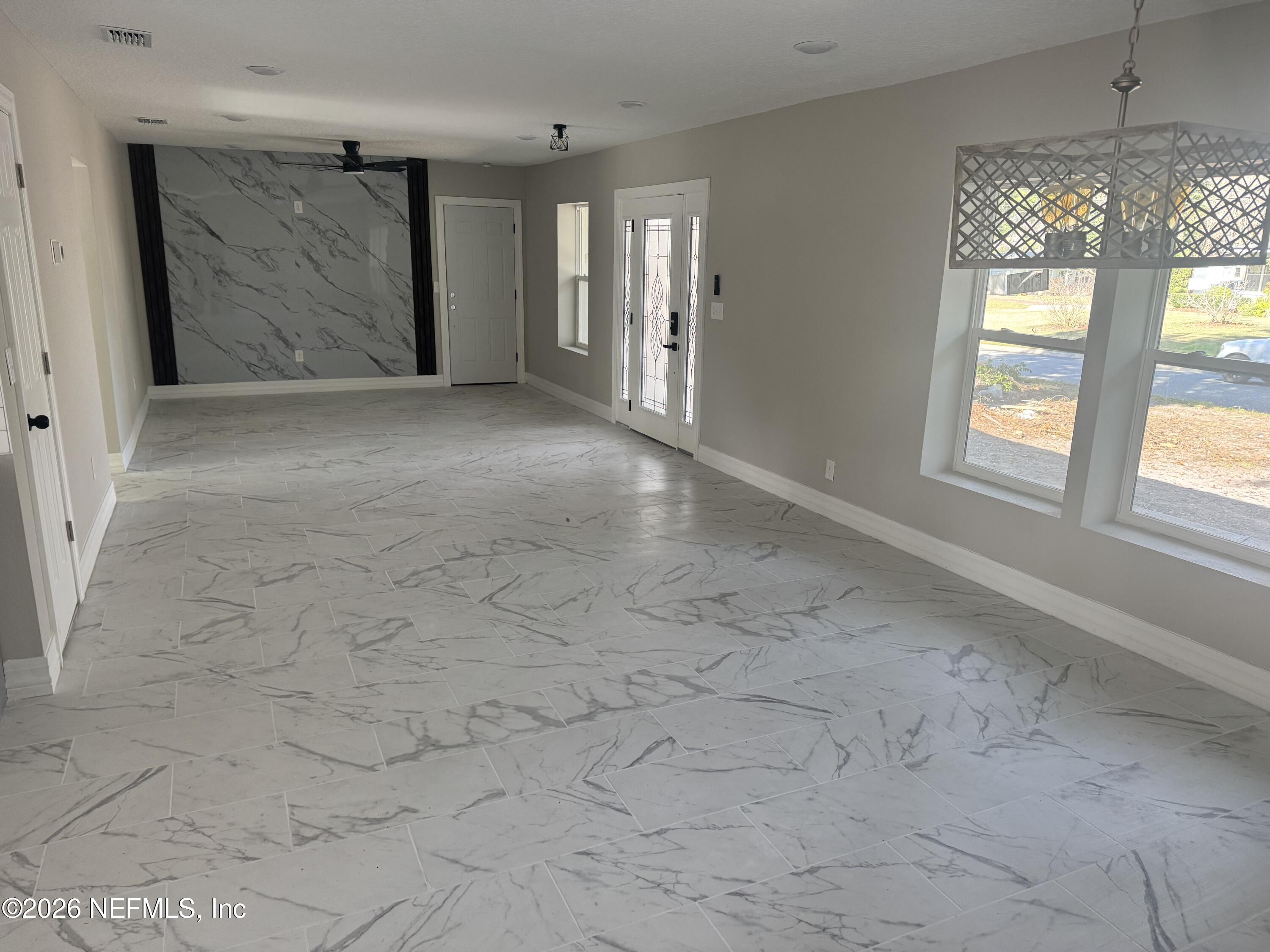 1718 Cornell Road Jacksonville, FL 32207 - Photo 16 of 35 an empty room with windows and chandelier