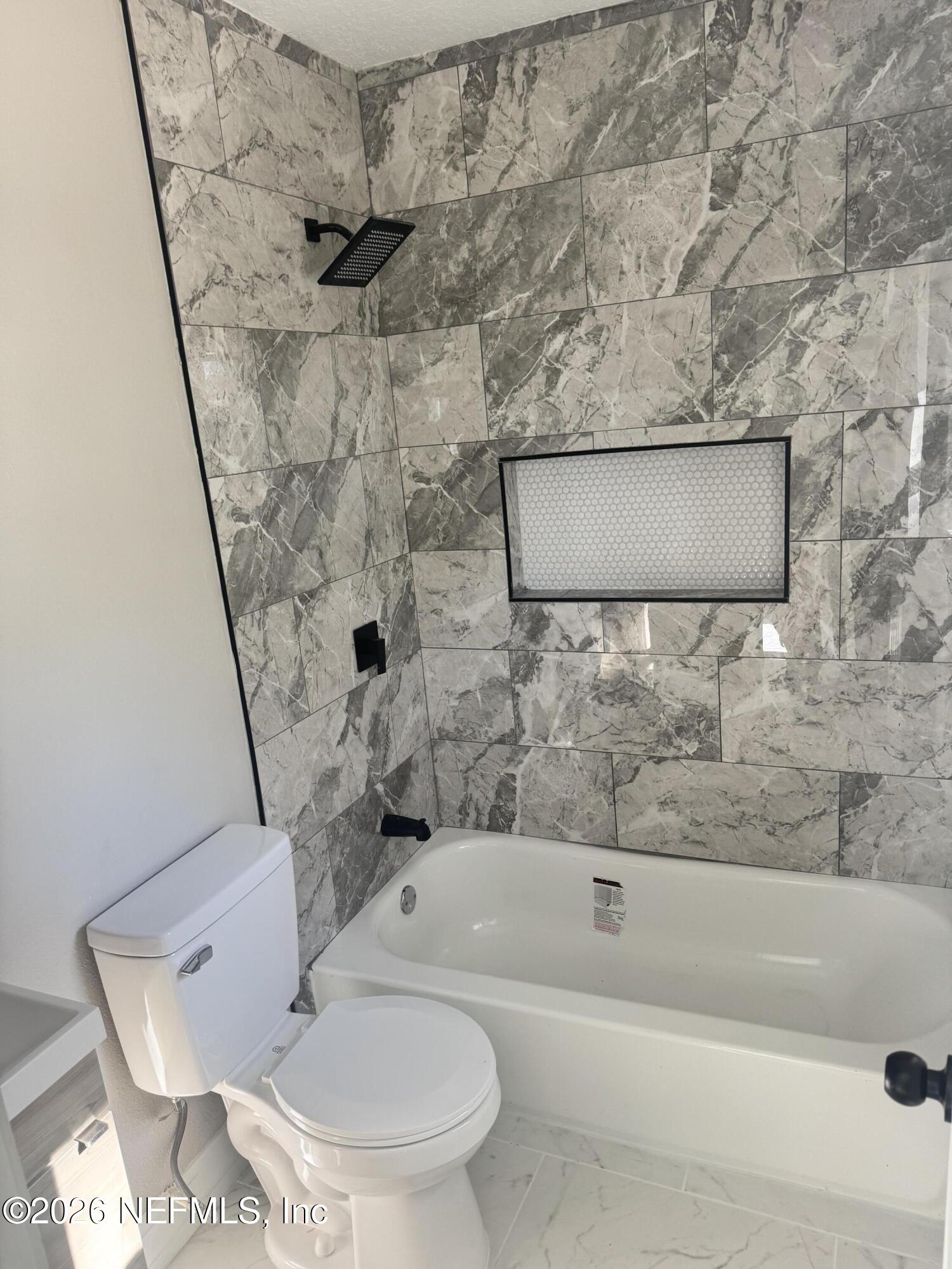 1718 Cornell Road Jacksonville, FL 32207 - Photo 22 of 35 a bathroom with a toilet and a bathtub