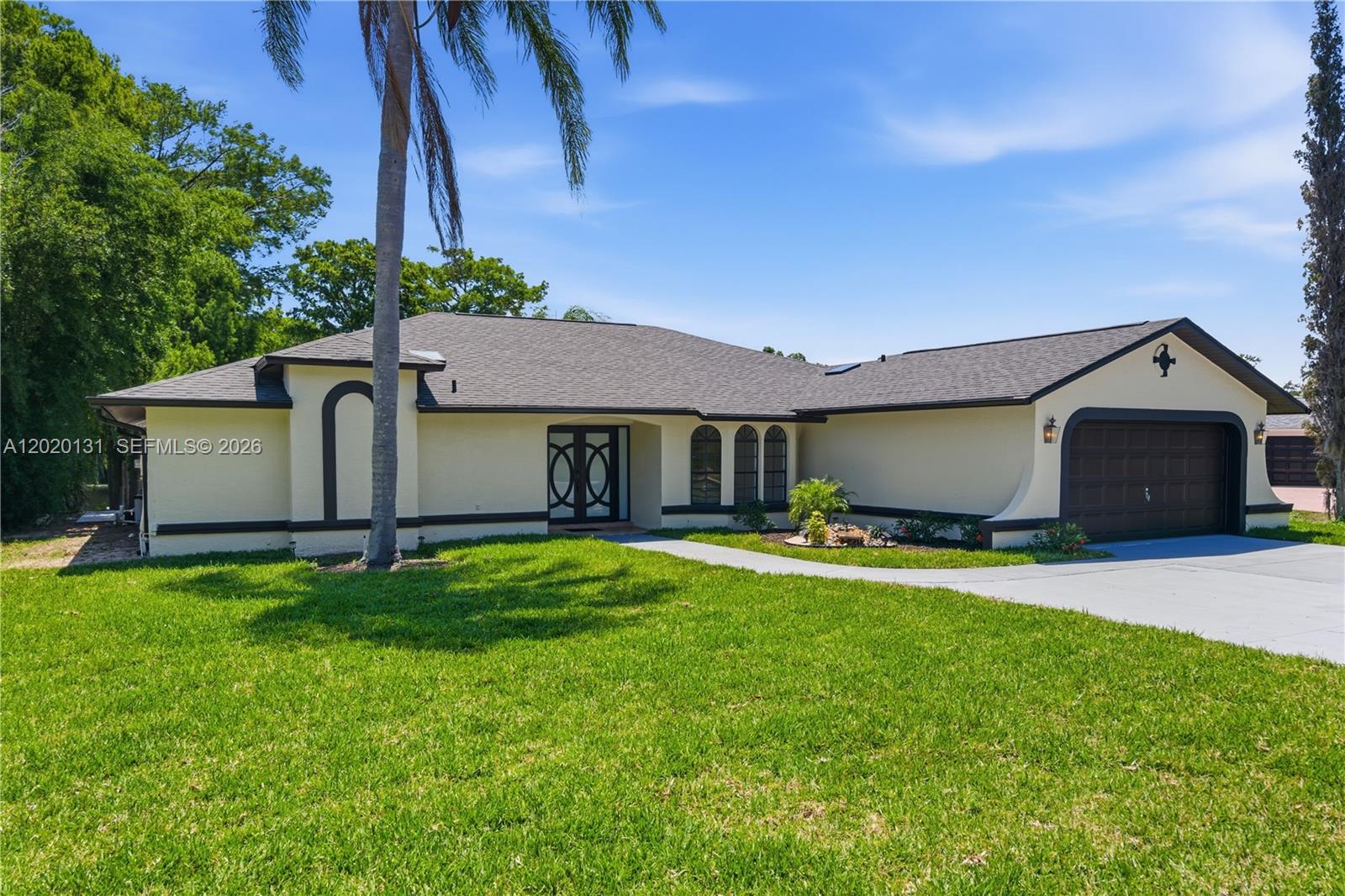 13408 Whitby Road Hudson, FL 34667 - Photo 24 of 30 a front view of a house with a garden and yard