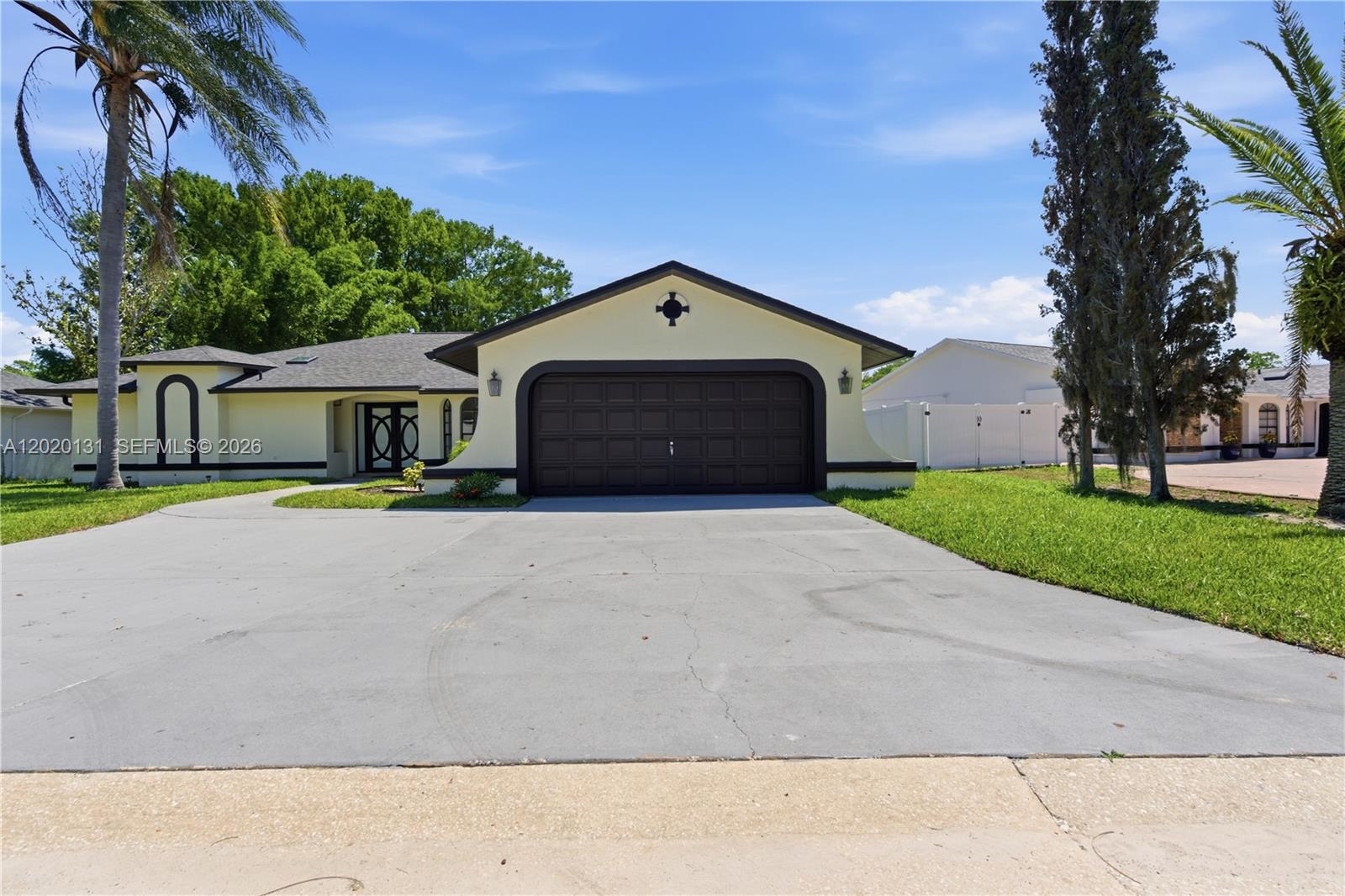 13408 Whitby Road Hudson, FL 34667 - Photo 25 of 30 a front view of a house with a yard and garage