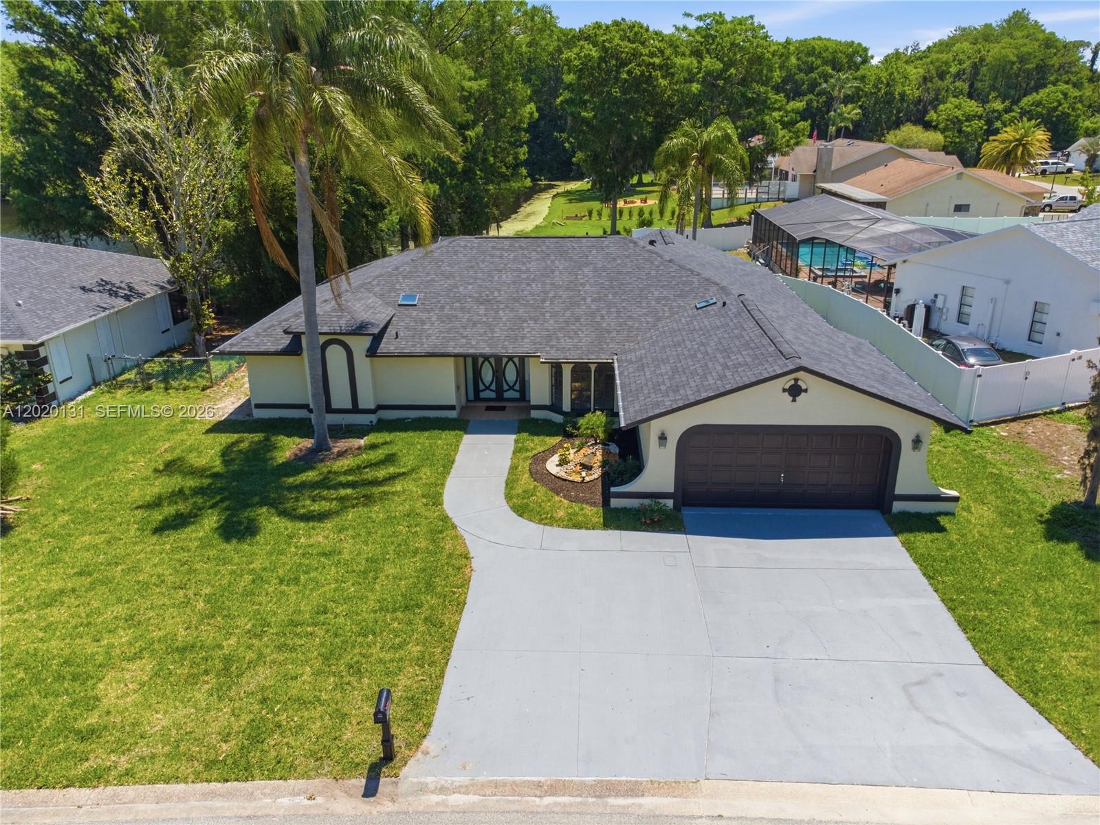 13408 Whitby Road Hudson, FL 34667 - Photo 26 of 30 a aerial view of a house with swimming pool and a yard
