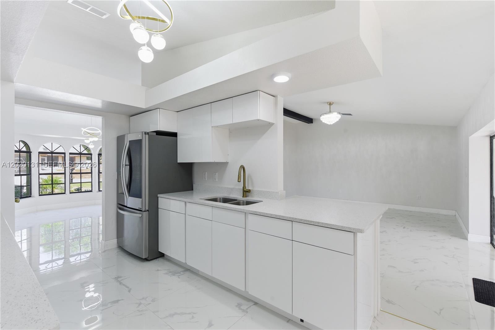 13408 Whitby Road Hudson, FL 34667 - Photo 7 of 30 a kitchen with a sink and stainless steel appliances