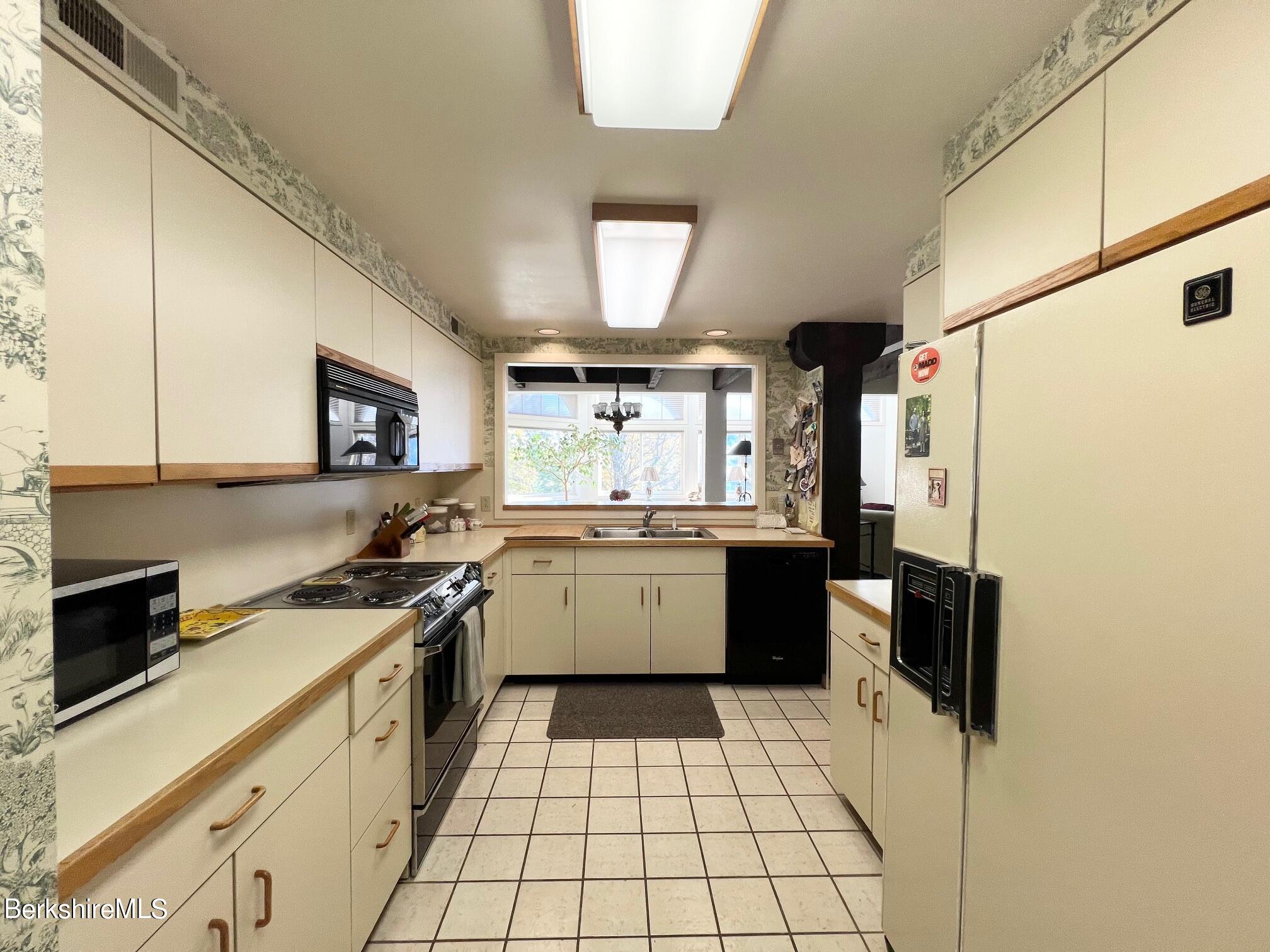 19 Hawthorne Road, Unit S2C Stockbridge, MA 01262 - Photo 20 of 41 a kitchen with a sink a stove a refrigerator and cabinets