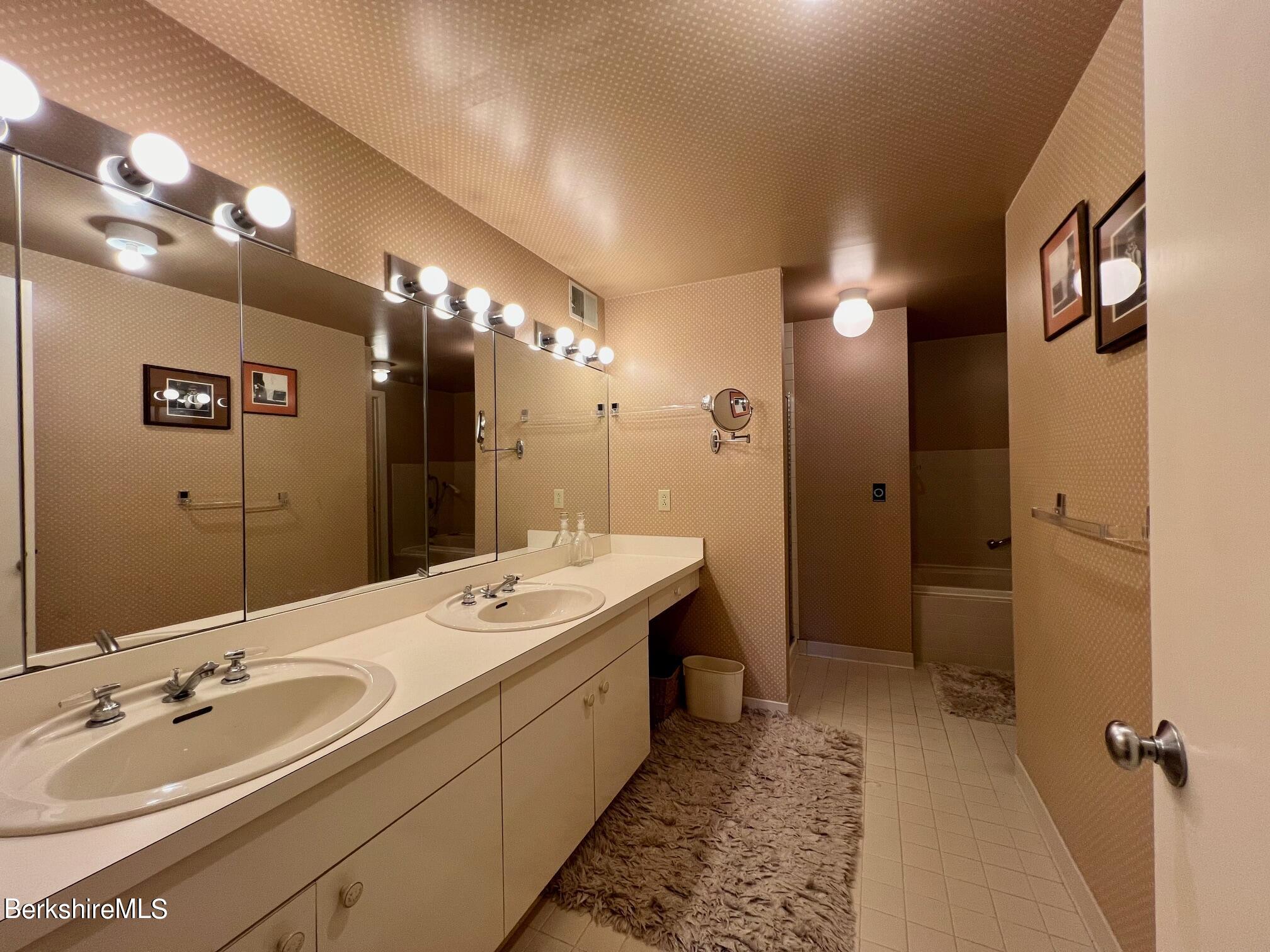 19 Hawthorne Road, Unit S2C Stockbridge, MA 01262 - Photo 25 of 41 a bathroom with a double vanity sink mirror and shower