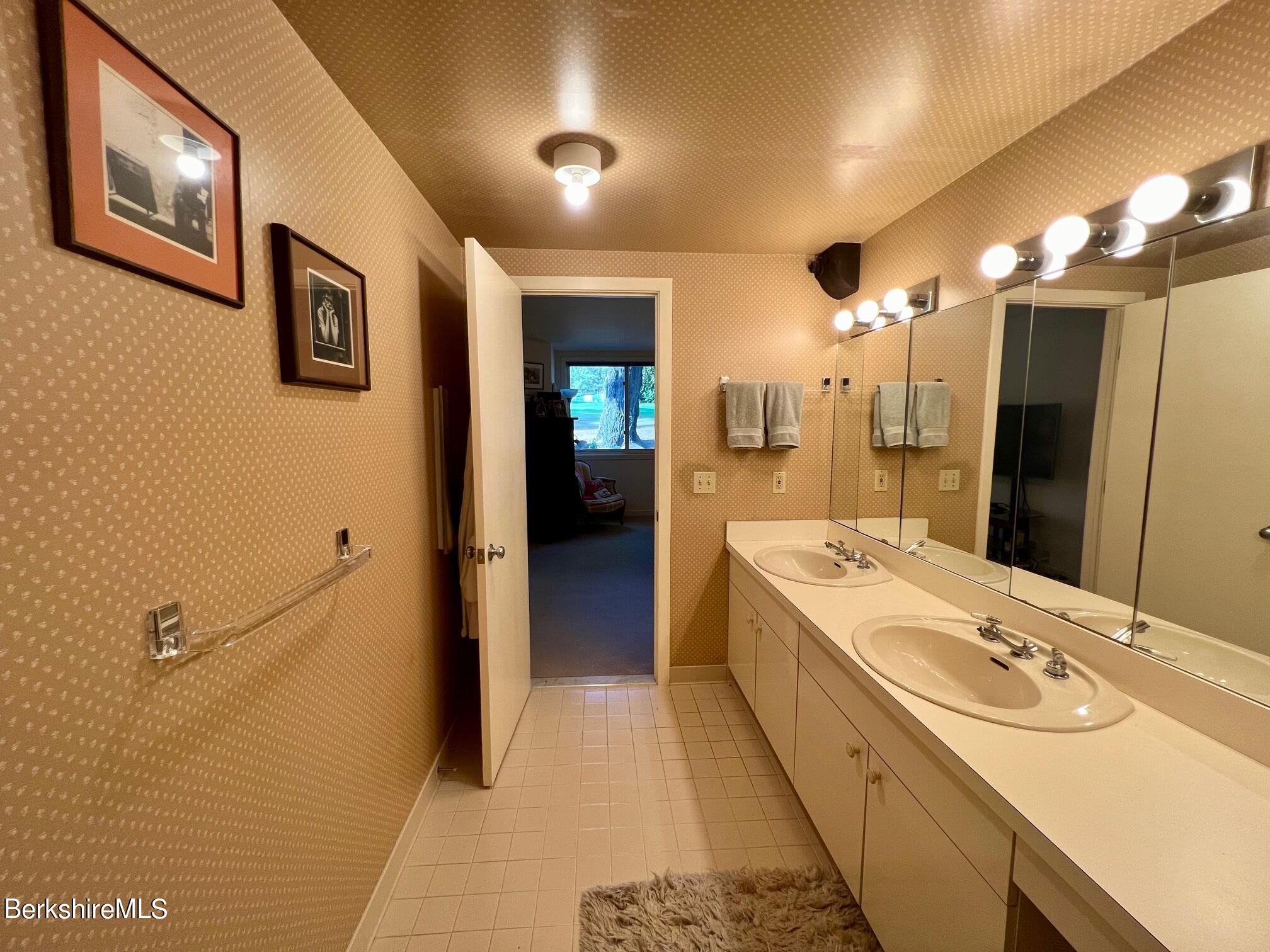 19 Hawthorne Road, Unit S2C Stockbridge, MA 01262 - Photo 27 of 41 a large bathroom with a double vanity sink and a mirror
