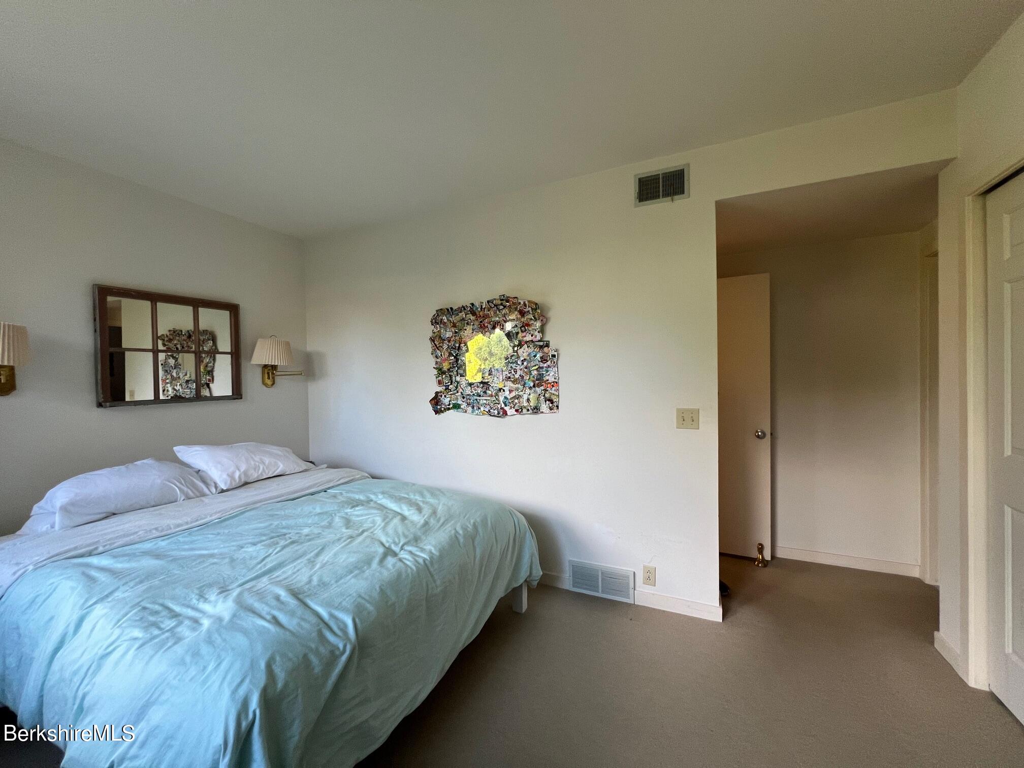 19 Hawthorne Road, Unit S2C Stockbridge, MA 01262 - Photo 30 of 41 a bedroom with a bed and a painting on the wall