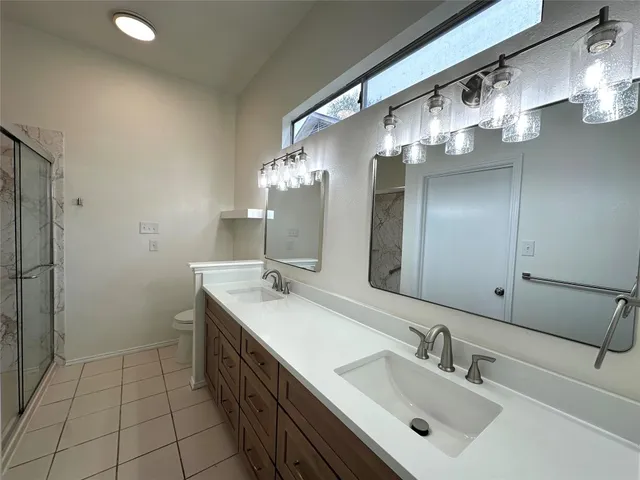 a bathroom with a double vanity sink and a mirror