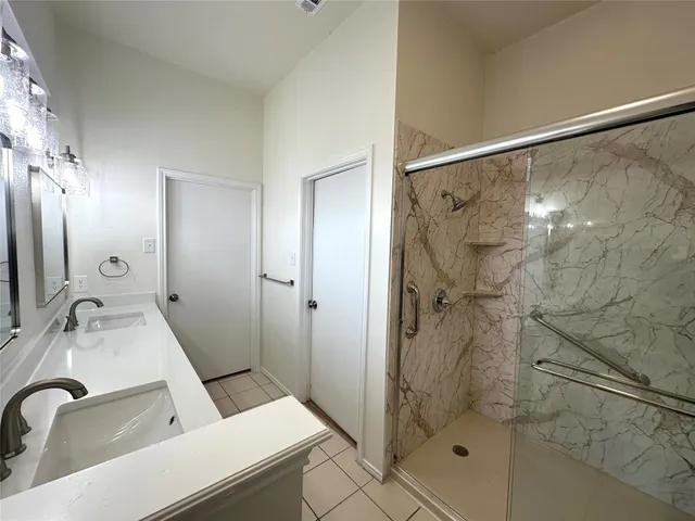 a bathroom with a sink and shower