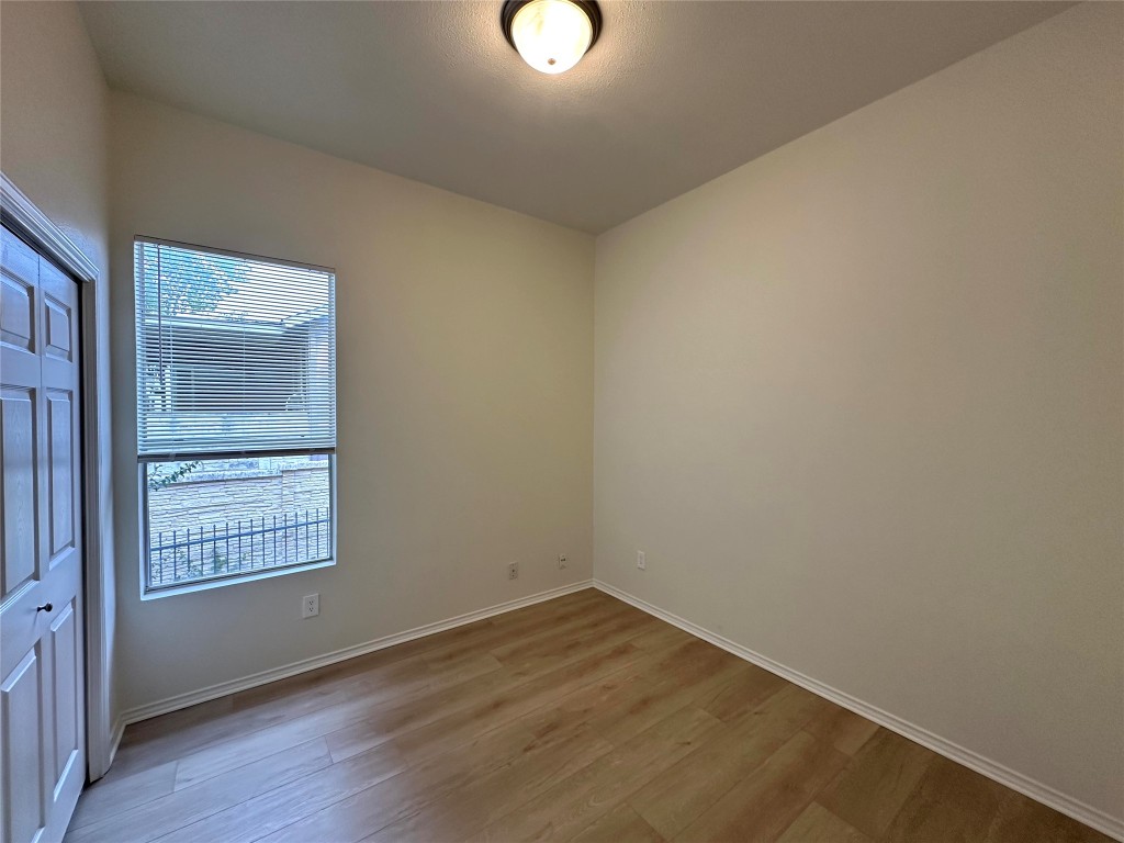 2105 Cervin Boulevard Austin, TX 78728 - Photo 16 of 22 an empty room with wooden floor and windows