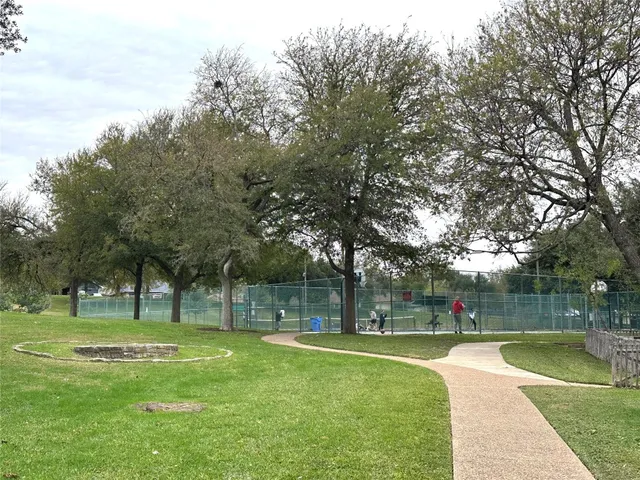 a view of a park with large trees