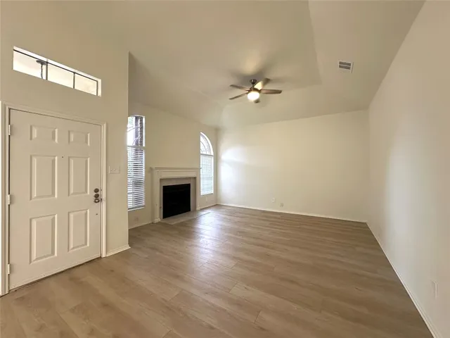 wooden floor in an empty room with a fireplace