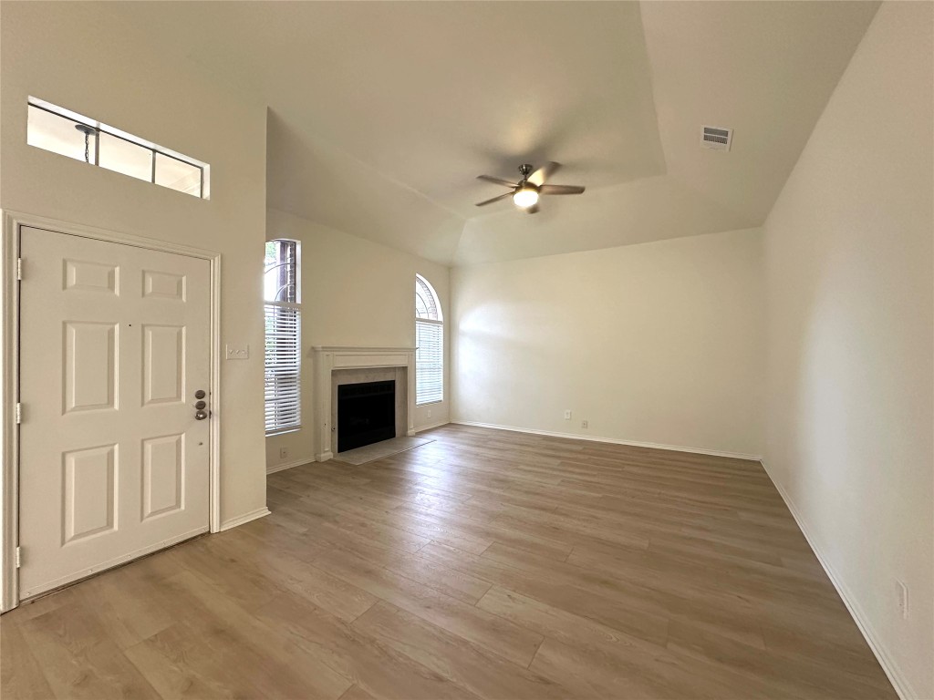 2105 Cervin Boulevard Austin, TX 78728 - Photo 4 of 22 wooden floor in an empty room with a fireplace