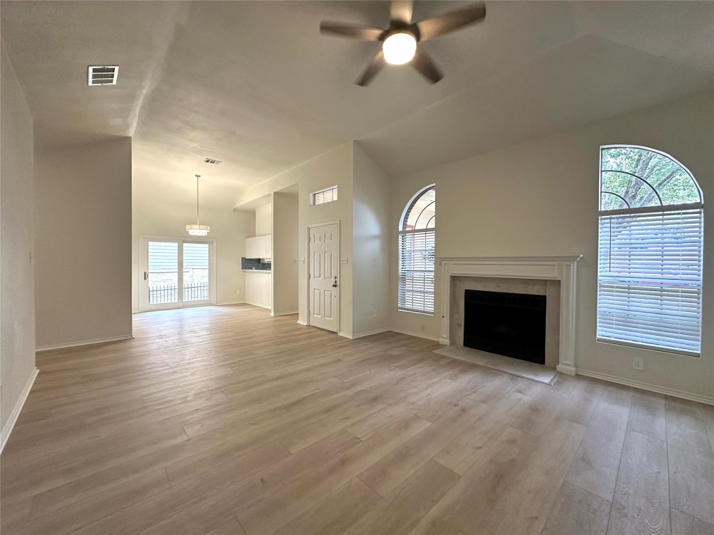 2105 Cervin Boulevard Austin, TX 78728 - Photo 5 of 22 a view of an empty room with a fireplace and a window