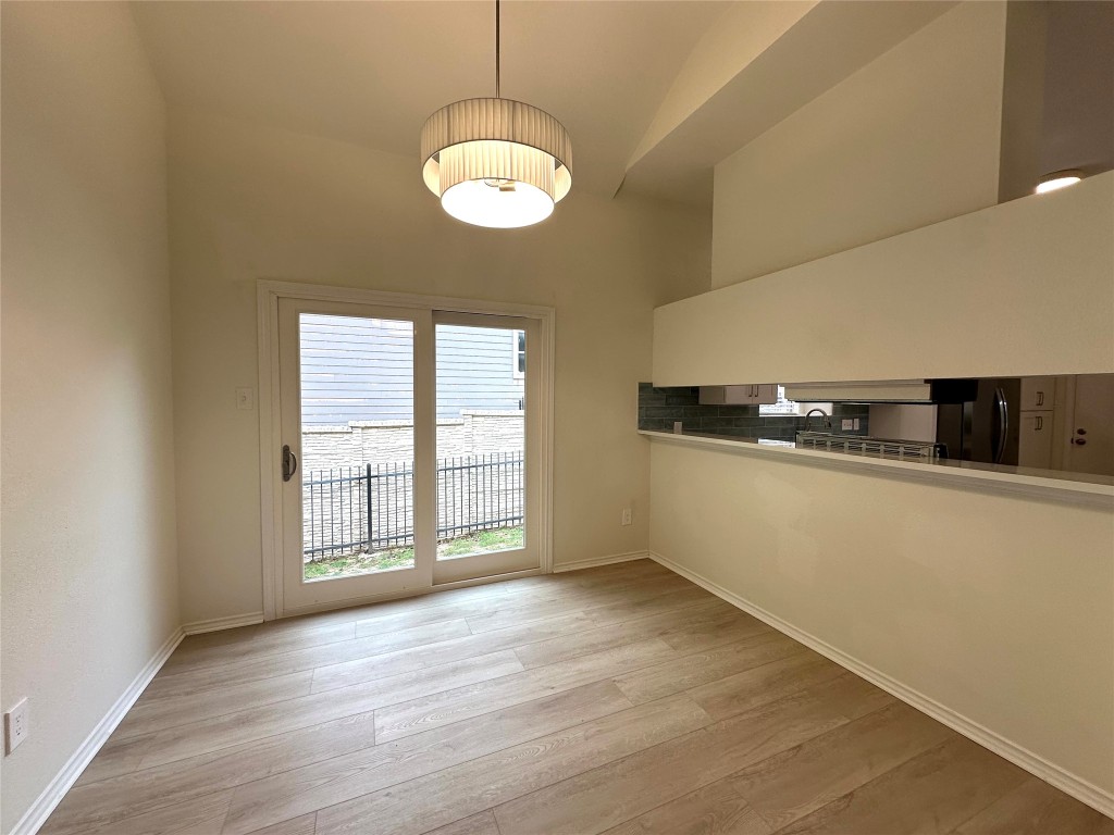 2105 Cervin Boulevard Austin, TX 78728 - Photo 6 of 22 an empty room with wooden floor and windows