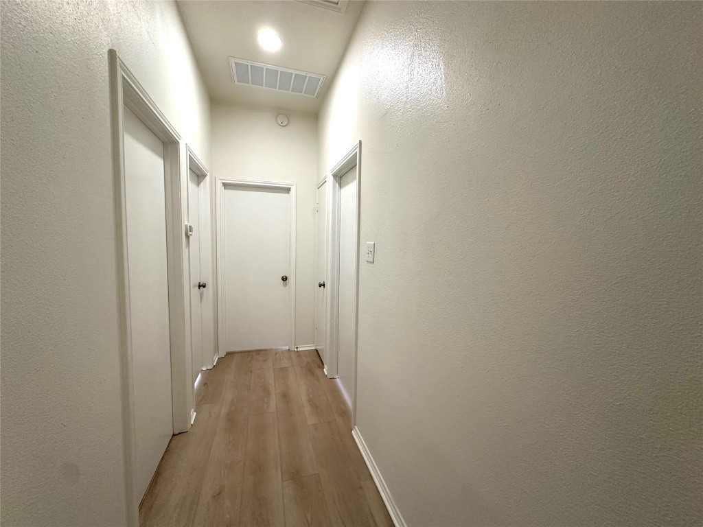 2105 Cervin Boulevard Austin, TX 78728 - Photo 9 of 22 a view of a hallway with wooden floor