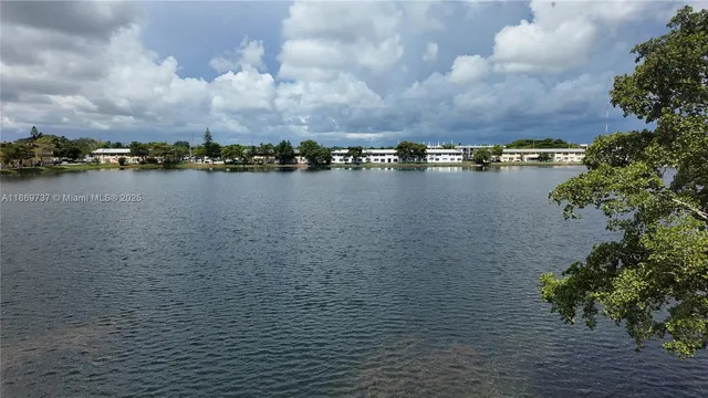 a view of a lake with houses in the back