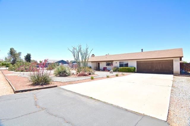 a front view of a house with a yard and a garage