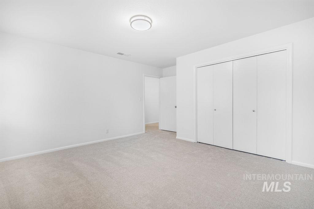 1561 Lenz Lane Boise, ID 83712 - Photo 11 of 29 Unfurnished bedroom featuring light carpet and a closet