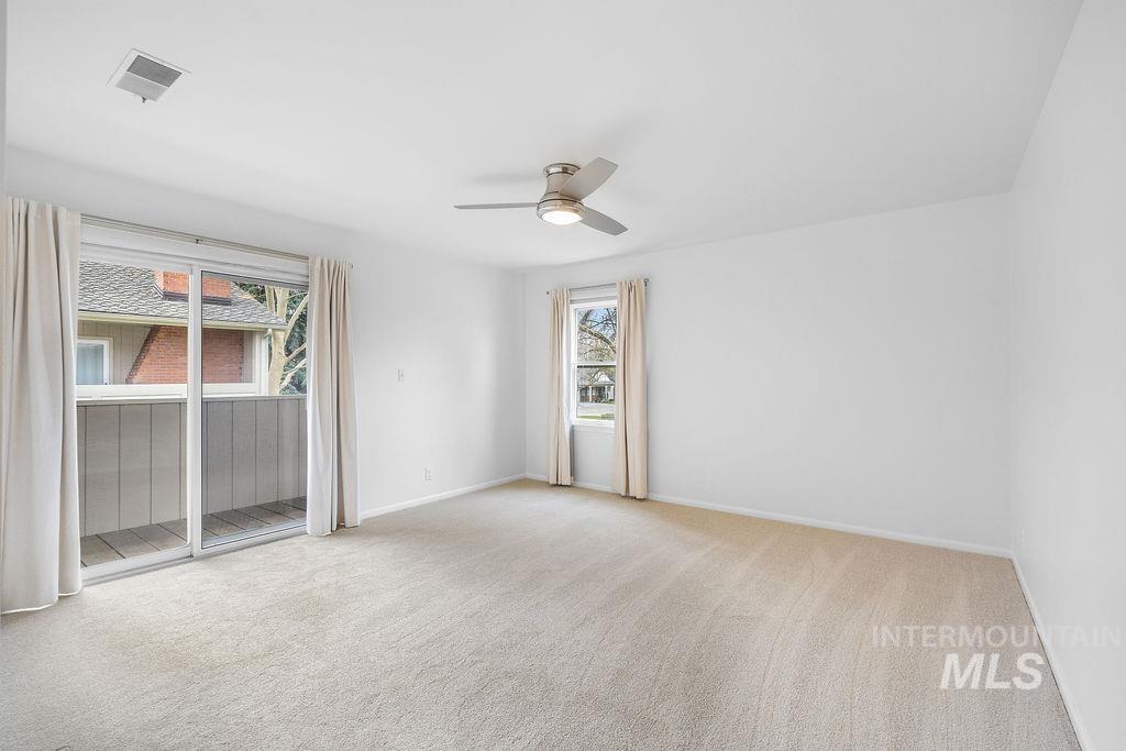 1561 Lenz Lane Boise, ID 83712 - Photo 15 of 29 Empty room featuring light carpet and ceiling fan