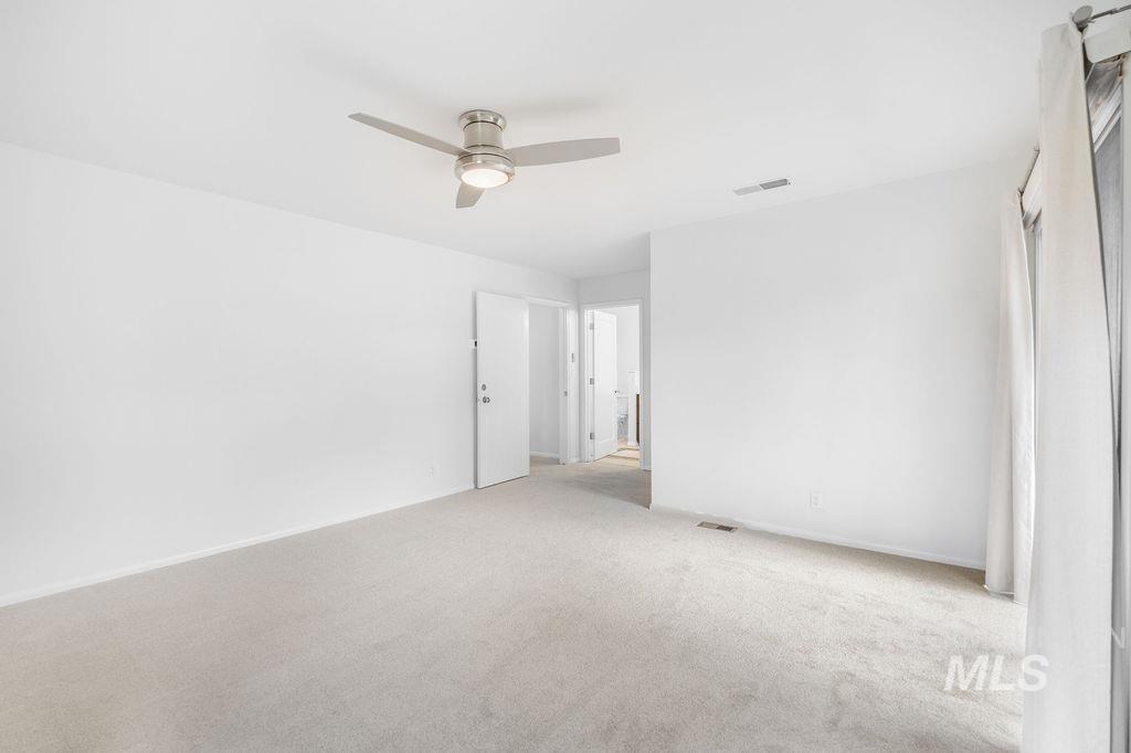 1561 Lenz Lane Boise, ID 83712 - Photo 18 of 29 Spare room featuring ceiling fan and carpet