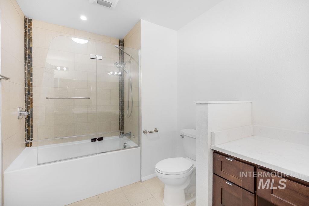 1561 Lenz Lane Boise, ID 83712 - Photo 20 of 29 Full bathroom with bath / shower combo with glass door, light tile patterned floors, vanity, and recessed lighting