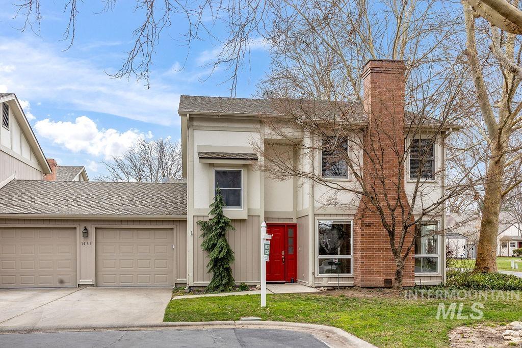1561 Lenz Lane Boise, ID 83712 - Photo 2 of 29 View of front of home with roof with shingles, a garage, a chimney, driveway, and board and batten siding