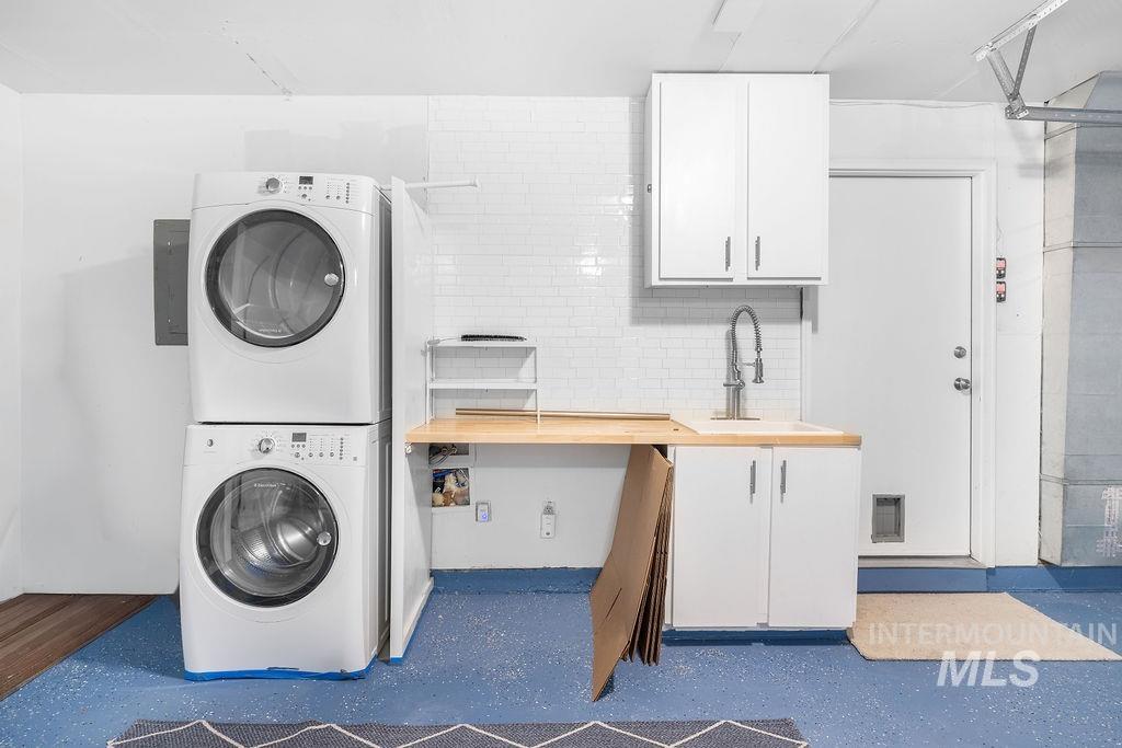 1561 Lenz Lane Boise, ID 83712 - Photo 23 of 29 Laundry area featuring stacked washer / dryer, cabinet space, and electric panel