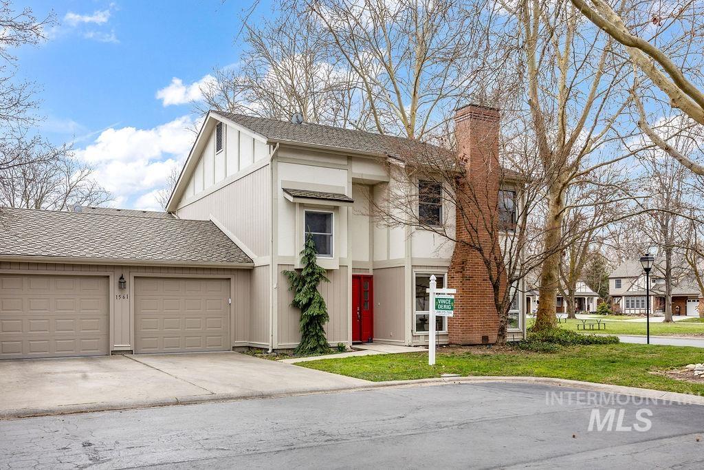 1561 Lenz Lane Boise, ID 83712 - Photo 29 of 29 View of front of house featuring a garage, a shingled roof, concrete driveway, and a chimney