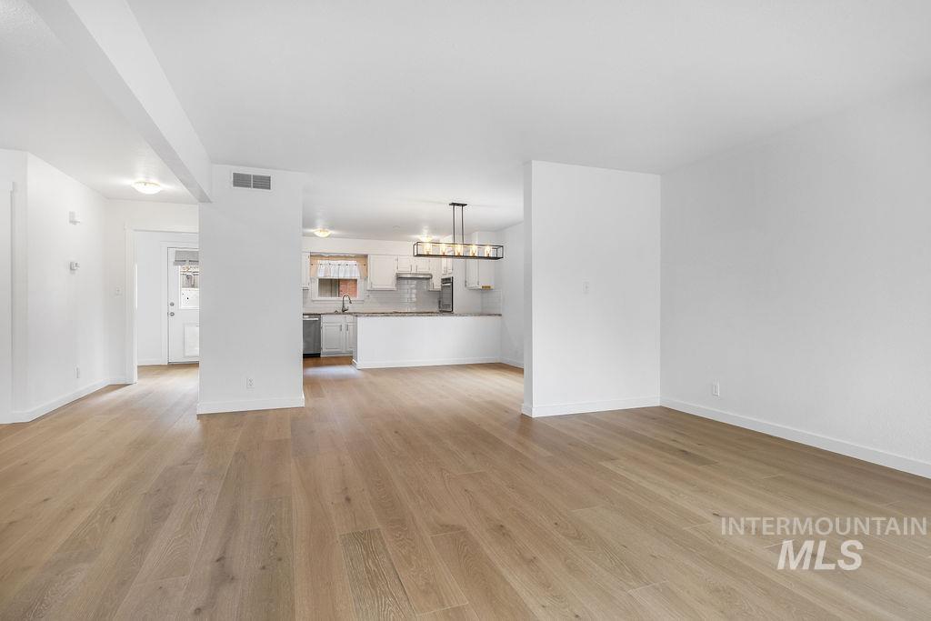 1561 Lenz Lane Boise, ID 83712 - Photo 5 of 29 Unfurnished living room featuring light wood-style flooring and baseboards