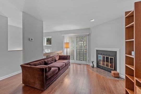 28 Alton Place, Unit A Brookline, MA 02446 - Photo 11 of 23 a living room with furniture and a fireplace