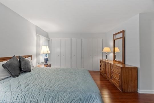 28 Alton Place, Unit A Brookline, MA 02446 - Photo 15 of 23 a bedroom with a bed and wooden floor