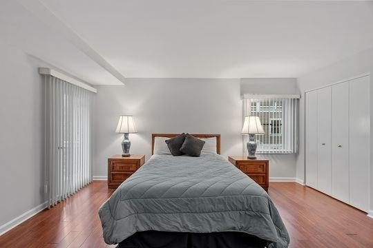 28 Alton Place, Unit A Brookline, MA 02446 - Photo 17 of 23 a bedroom with a bed and wooden floor