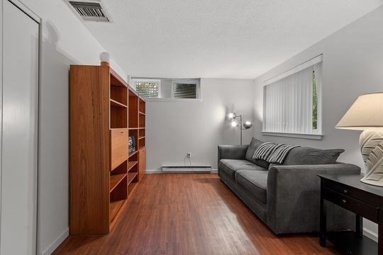 28 Alton Place, Unit A Brookline, MA 02446 - Photo 18 of 23 a living room with furniture and a wooden floor
