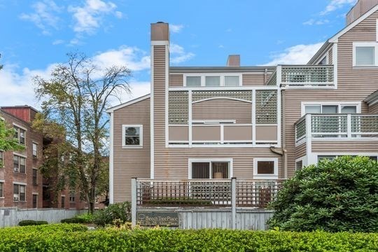 28 Alton Place, Unit A Brookline, MA 02446 - Photo 3 of 23 a front view of a building with a garden and plants