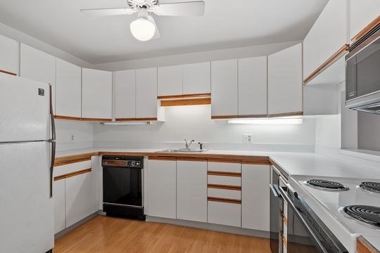 28 Alton Place, Unit A Brookline, MA 02446 - Photo 6 of 23 a kitchen with cabinets appliances and a sink