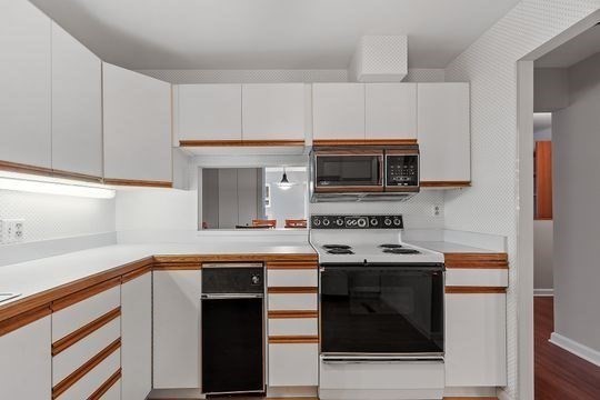 28 Alton Place, Unit A Brookline, MA 02446 - Photo 7 of 23 a kitchen with cabinets stainless steel appliances and a sink
