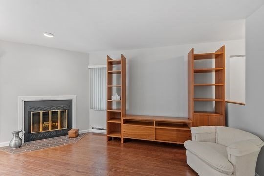 28 Alton Place, Unit A Brookline, MA 02446 - Photo 8 of 23 a room with furniture and a fireplace