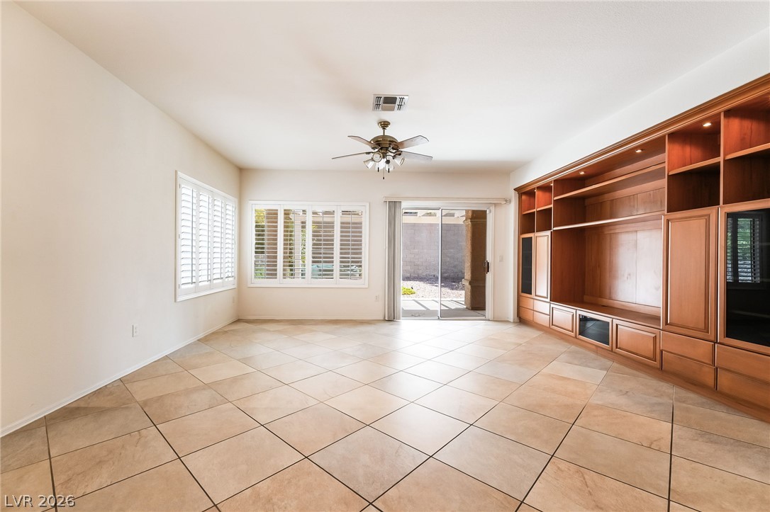 3033 Hartsville Road Henderson, NV 89052 - Photo 17 of 41 Well-lit living area featuring an entertainment built-in and convenient patio access.