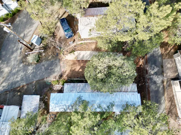 an aerial view of a house with a yard