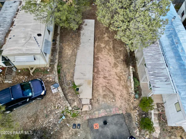 an aerial view of a house with a yard pool outdoor seating