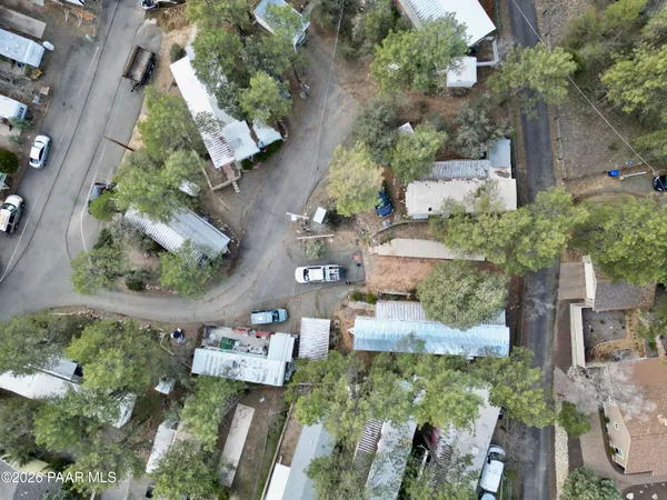 an aerial view of a house with a yard and a large tree