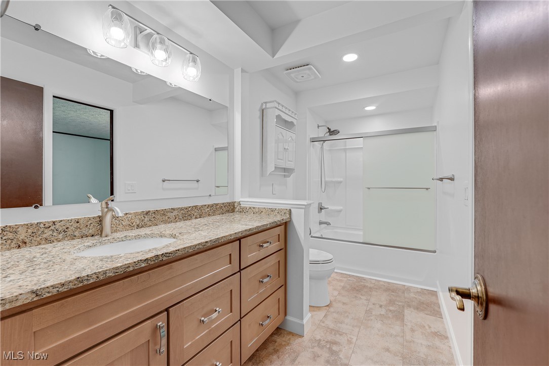 123 Boulder Ridge Place Painesville, OH 44077 - Photo 10 of 28 Bathroom featuring shower / bath combination with glass door, vanity, recessed lighting, and light tile patterned floors