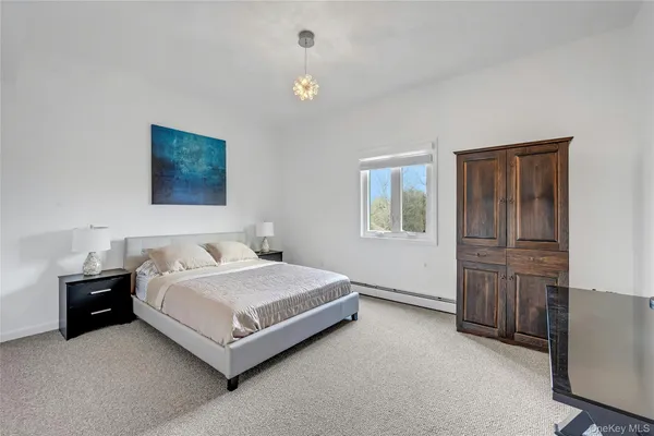 a bedroom with a bed and cabinet