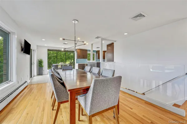 a view of a dining room with furniture window and wooden floor