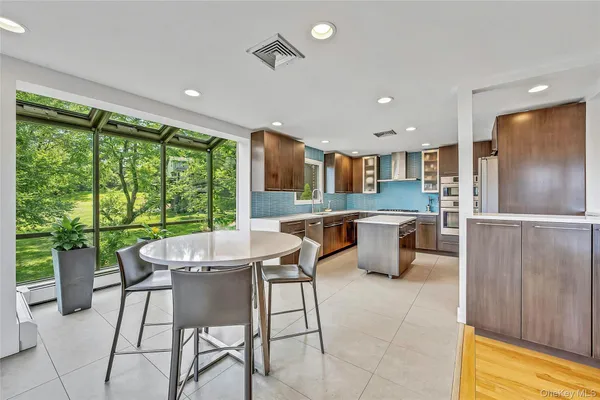 a kitchen with a table chairs and refrigerator