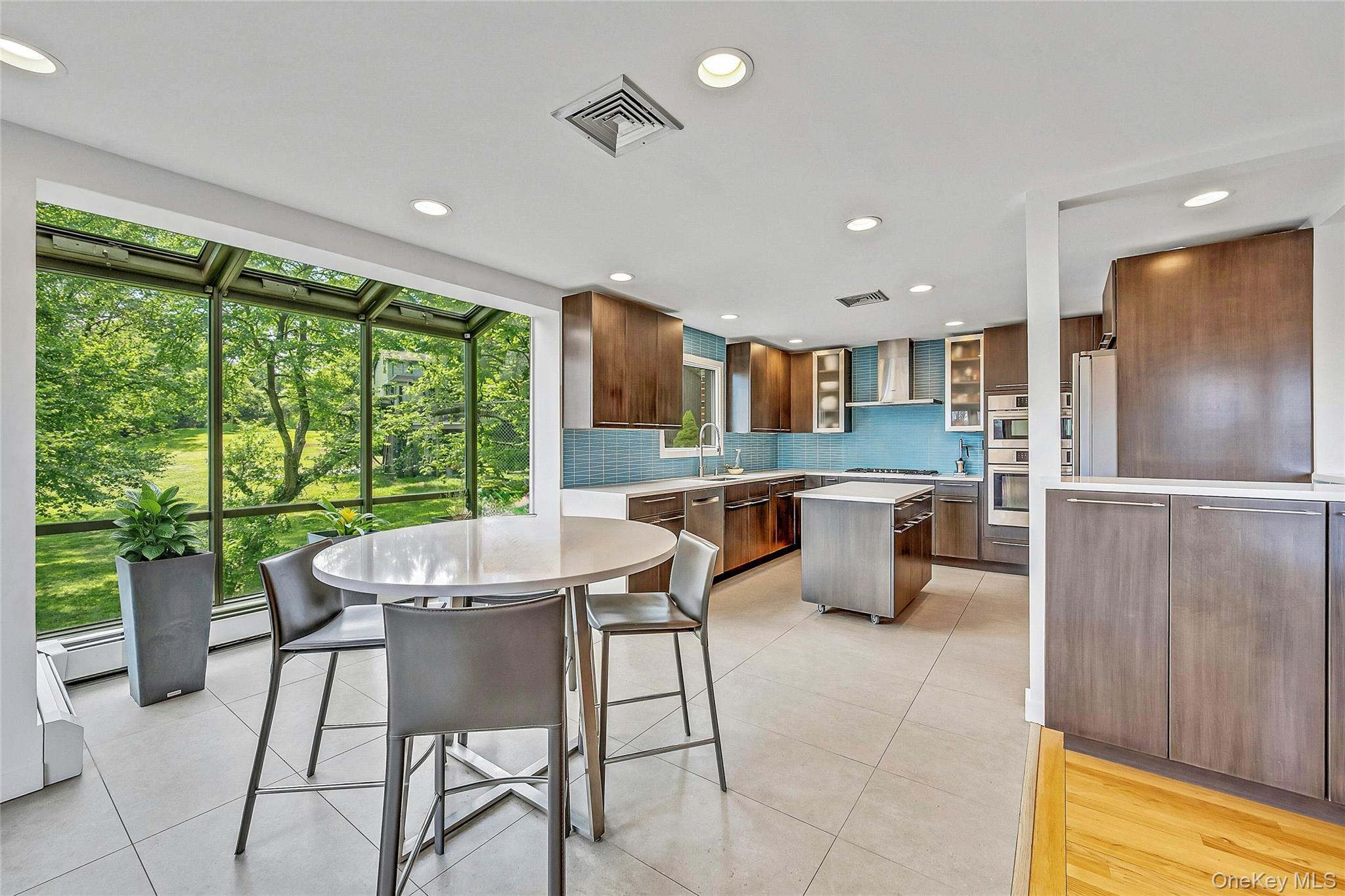 33 Hirst Road Briarcliff Manor, NY 10510 - Photo 6 of 25 a kitchen with a table chairs and refrigerator
